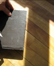 1. Place a hard covered book on the floor with the bottom or top edge lined up with a shadow.
