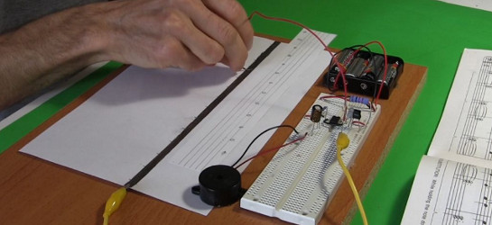 Music instrument made using a 555 timer chip circuit, paper and pencil.