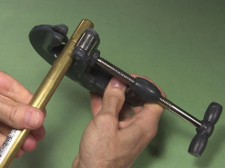 Cutting a brass tube with a pipe cutter.