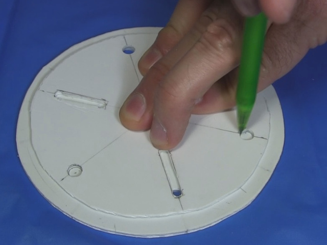 Tracing the hole positions onto another disk.