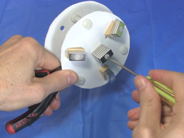 Putting the center magnets on the disk using another nylon bolt and nut.