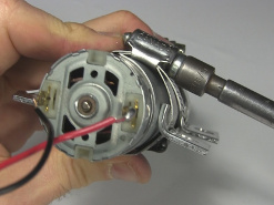 Attaching the brackets to a BB-8 drill motor using hose clamps.