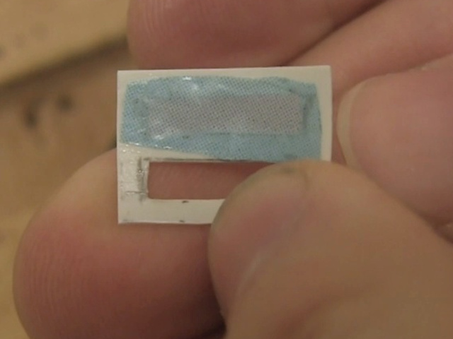 Blue plastic from food packaging glued to thin plastic.