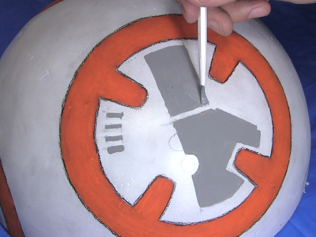 Painting grey details in the circles on BB-8's ball.
