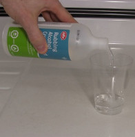 Pouring alcohol to make a dilute mixture of chlorophyll.