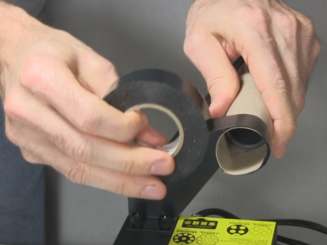 Putting tape on the end of the carboard tube.