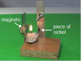 Magnetized nickel away from the flame in the Curie temperature experiment.