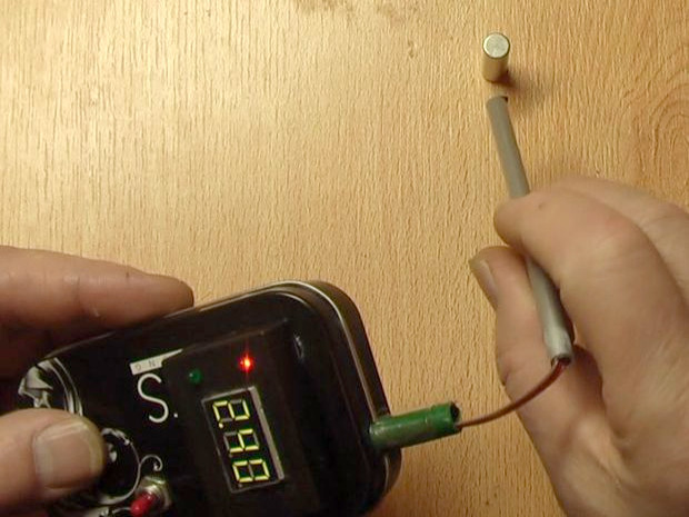 Showing the gauss meter's flexibility by extending the probe on the end of wires.