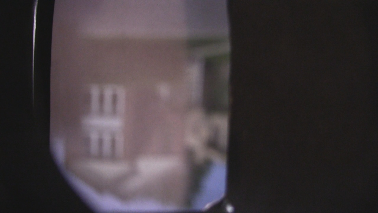The view of some houses on the screen inside the pinhole camera.