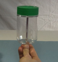 Balancing the jar with its lid on the pen.