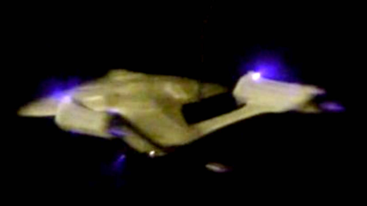 Star Trek Enterprise model being propelled with ion propulsion as an ionocraft, rear view.