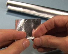 Rolling up a piece of aluminum foil for the Enterprise nacelles for ion propulsion.