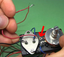 A red wire is soldered to the potentiometer...