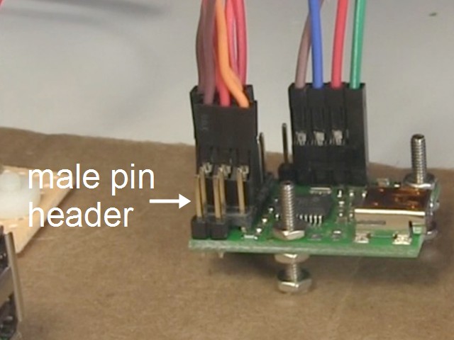 The two pins of the male pin header on the Maestro motor controller board.