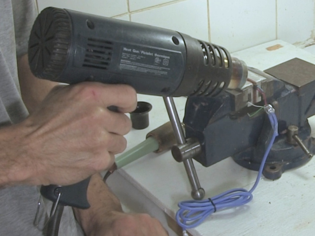 Using the heat gun to shrink the heat shrink tubing.