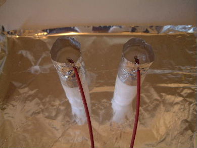 Poured paraffin wax using an aluminum tape mold over the wire 
      ends of the needles for insulation.